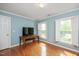 Bright bedroom featuring hardwood floors, two windows with white shutters and blue painted walls at 8508 Kayenta Ct, Wake Forest, NC 27587