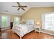 Vaulted ceiling bedroom with hardwood floors, a ceiling fan, and natural lighting at 8508 Kayenta Ct, Wake Forest, NC 27587