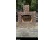 Brick fireplace with a stone base and a metal grate at 8508 Kayenta Ct, Wake Forest, NC 27587