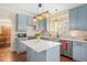 Kitchen featuring updated cabinetry, island, and stainless steel appliances at 8508 Kayenta Ct, Wake Forest, NC 27587