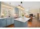 Open concept kitchen featuring updated cabinetry, island, and stainless steel appliances at 8508 Kayenta Ct, Wake Forest, NC 27587