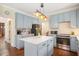 Eat in kitchen featuring updated cabinetry, island, and stainless steel appliances at 8508 Kayenta Ct, Wake Forest, NC 27587