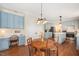 Eat-in kitchen featuring blue cabinets, an island, and hardwood floors open to the rest of the home at 8508 Kayenta Ct, Wake Forest, NC 27587