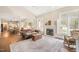 Open-concept living area with a fireplace, hardwood floors, high ceilings, and view into the kitchen at 8508 Kayenta Ct, Wake Forest, NC 27587
