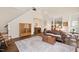 Spacious living room with high ceilings, hardwood floors, rug and a view into the kitchen area at 8508 Kayenta Ct, Wake Forest, NC 27587