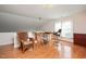 Sunlit office space featuring hardwood floors, a desk setup, and large windows at 8508 Kayenta Ct, Wake Forest, NC 27587