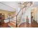 Elegant foyer staircase with wood steps, white risers, and wood railing leading to the second floor at 8508 Kayenta Ct, Wake Forest, NC 27587