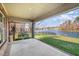 Covered back patio with seating overlooks lush lawn and serene lake views at 915 Dunleigh Dr, Burlington, NC 27215