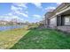 Waterfront property with brick patio, lush green lawn, and serene lake views, perfect for outdoor enjoyment at 915 Dunleigh Dr, Burlington, NC 27215