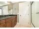 Bathroom featuring walk-in shower, wood vanity, granite countertops and tile floors at 915 Dunleigh Dr, Burlington, NC 27215