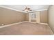 Bedroom with large window bringing in natural light, neutral walls, carpet and ceiling fan at 915 Dunleigh Dr, Burlington, NC 27215