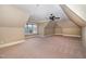 Large attic bedroom with window bringing in natural light, and a ceiling fan at 915 Dunleigh Dr, Burlington, NC 27215