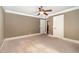 Spacious bedroom featuring neutral walls, carpet, ceiling fan and white trim and doors at 915 Dunleigh Dr, Burlington, NC 27215