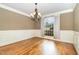 Formal dining room showcasing hardwood floors, wainscoting, and a large window at 915 Dunleigh Dr, Burlington, NC 27215