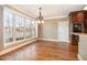 Bright dining room with lake view, chandelier, and access to the kitchen at 915 Dunleigh Dr, Burlington, NC 27215
