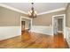 Formal dining room with hardwood floors, wainscoting, and elegant chandelier at 915 Dunleigh Dr, Burlington, NC 27215