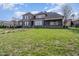 Large brick home with a stone walkway, mature trees, and well-maintained lawn at 915 Dunleigh Dr, Burlington, NC 27215