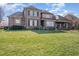 Large brick home with black shutters, a well-maintained lawn, and mature landscaping at 915 Dunleigh Dr, Burlington, NC 27215