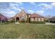 Beautiful two-story stone and brick home with mature landscaping and a well manicured lawn at 915 Dunleigh Dr, Burlington, NC 27215