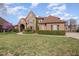 Beautiful two-story stone and brick home with mature landscaping and a well manicured lawn at 915 Dunleigh Dr, Burlington, NC 27215
