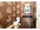 Elegant powder room with custom wall design, dark wood vanity and a framed mirror, offering a stylish and functional space at 915 Dunleigh Dr, Burlington, NC 27215