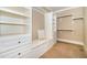 Custom walk-in closet with built-in shelving and drawers, providing ample storage and organization at 915 Dunleigh Dr, Burlington, NC 27215