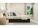 Peaceful bedroom features a dark-framed bed, soft pillows, a bedside table, and an arched mirror at 920 Jasper Mine Trl, Raleigh, NC 27610
