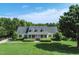 Beautiful home featuring a spacious front yard, lush landscaping, and mature trees at 98 Lochridge Dr, Roxboro, NC 27573