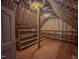 Storage attic featuring wooden flooring, insulation, shelving, and space for storing belongings at 98 Lochridge Dr, Roxboro, NC 27573