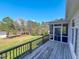 View of the screened porch and backyard from this home's wooden back deck at 98 Lochridge Dr, Roxboro, NC 27573