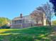 Back exterior view of the home featuring a deck, screened porch, and spacious backyard at 98 Lochridge Dr, Roxboro, NC 27573