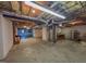 Partially finished basement with exposed insulation, utilities, and a brick fireplace at 98 Lochridge Dr, Roxboro, NC 27573