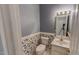 Half bathroom featuring vintage patterned wallpaper, a pedestal sink, and a toilet with matching hardware at 98 Lochridge Dr, Roxboro, NC 27573