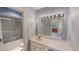 Bathroom features blue wallpaper, a vanity with a mirror, and a shower/tub combination at 98 Lochridge Dr, Roxboro, NC 27573
