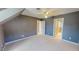 Bedroom features gray walls, a ceiling fan, and two entryways leading to other rooms at 98 Lochridge Dr, Roxboro, NC 27573
