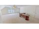 Spacious bonus room with large windows, neutral carpet, and ceiling fan at 98 Lochridge Dr, Roxboro, NC 27573