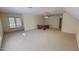 Expansive bonus room with neutral carpeting, a ceiling fan, and natural light at 98 Lochridge Dr, Roxboro, NC 27573