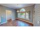 Dining room with hardwood floors, large windows, and blue wallpaper at 98 Lochridge Dr, Roxboro, NC 27573