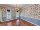 Formal dining room with traditional wallpaper, trim, and hardwood floors at 98 Lochridge Dr, Roxboro, NC 27573