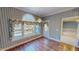 Dining room with hardwood floors, blue wallpaper, and a view of the deck at 98 Lochridge Dr, Roxboro, NC 27573