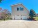 Spacious two-car garage and additional living space with a well-maintained lawn on a sunny day at 98 Lochridge Dr, Roxboro, NC 27573