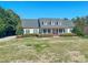 Charming single-Gathering home boasts a covered front porch and beautifully landscaped front yard at 98 Lochridge Dr, Roxboro, NC 27573