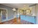 Eat-in kitchen with plaid wallpaper and white cabinets offers a cozy and unique design at 98 Lochridge Dr, Roxboro, NC 27573