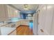 The kitchen features white cabinets and a view into the breakfast nook area at 98 Lochridge Dr, Roxboro, NC 27573