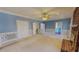 Large living room features plush carpeting, brick fireplace, and doors leading to the other parts of the home at 98 Lochridge Dr, Roxboro, NC 27573