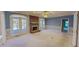 Open living room featuring a brick fireplace and direct access to the outdoor deck at 98 Lochridge Dr, Roxboro, NC 27573