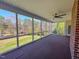 Screened porch with a ceiling fan and backyard views at 98 Lochridge Dr, Roxboro, NC 27573