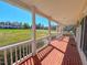 Inviting porch features red brick flooring, white columns, and views of the community at 98 Lochridge Dr, Roxboro, NC 27573