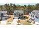 Expansive aerial shot showcases a home with a well-manicured lawn and tree-lined surroundings in a peaceful neighborhood at 104 Chaseford Ct, Holly Springs, NC 27540