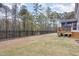 Spacious backyard with an iron fence and lush trees for added privacy at 104 Chaseford Ct, Holly Springs, NC 27540